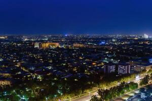 Uzbekistan, Tashkent - September 29, 2023 Top view from the observation deck on the Tashkent TV tower to the central part of the city covered with smog at nighttime . Air polution. photo