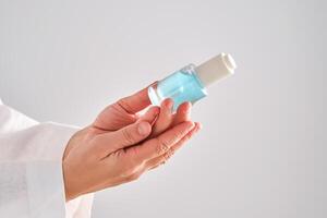 Blue serum with pipette in a womans hands in a robe. photo