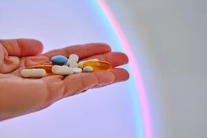 Vitamins and dietary supplements on the palm against the luminous circle. photo