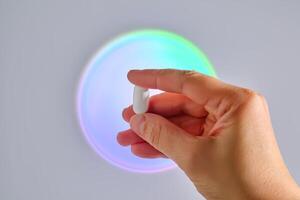 Tablet in hand against the background of a glowing circle. photo