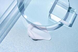 A smear of cream against a background of glass prisms on a blue background. photo