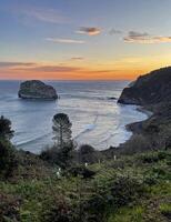 Oceanfront at San Juan de Gaztelugatxe in Spain during sunrise photo