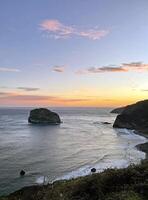 Oceanfront at San Juan de Gaztelugatxe in Spain during sunrise photo