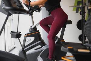 Woman was running on the treadmill in the gym. photo