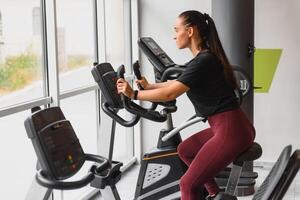 Woman was running on the treadmill in the gym. photo