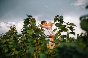 Portrait of cute little girl held in father's arms. Happy loving family. Father and his daughter child girl playing hugging. Cute baby and daddy. photo