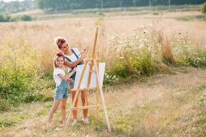 family, children and people concept - happy mother and daughter drawing and talking over green background. Mother's Day. photo