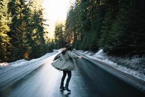 Photo from back of girl with hat in forest at mountain road. Relax time on holiday concept travel ,color of vintage tone and soft focus.