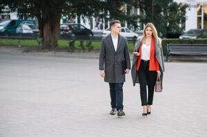 Young business people walking together along the street photo