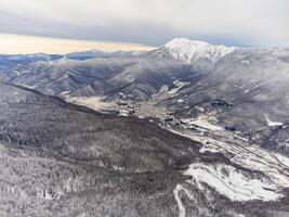 View of the winter sunset and snow-covered mountains in Sochi photo