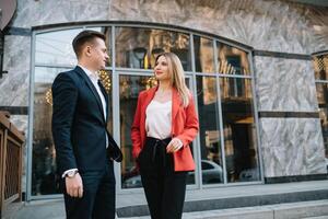 Business people walking and talking in the street ear of modern building. photo