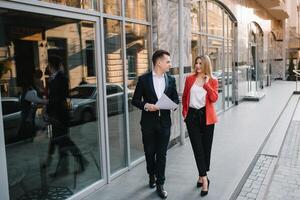 Business people walking and talking in the street photo