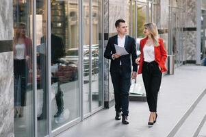 Handsome man in suit is looking at his watch attentively. He is waiting for his business partner. Look Exquisitely Stylish. photo