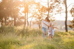 Stylish mother and handsome daughter having fun on the nature. Happy family concept. Beauty nature scene with family outdoor lifestyle. family resting together. Happiness in family life. Mothers day. photo