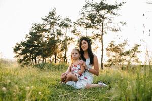 Mother and daughter having fun in the park. Happiness and harmony in family life. Beauty nature scene with family outdoor lifestyle photo