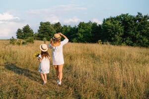 Mother and daughter having fun in the park. Happiness and harmony in family life. Beauty nature scene with family outdoor lifestyle. Mother's Day photo