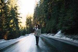 Happy girl with hat in forest at mountain road background, Relax time on holiday concept travel ,color of vintage tone and soft focus. photo