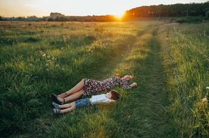 Stilish mother and handsome son having fun on the nature. Happy family concept. Beauty nature scene with family outdoor lifestyle. Happy family resting together. Happiness in family life. Mothers day photo