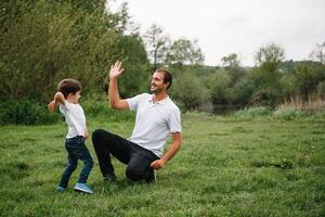 Happy man and his child having fun outdoors. Family lifestyle rural scene of father and son in sunset sunlight. concept of a happy family. photo