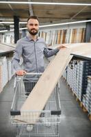 Man choosing flooring in hardware store photo