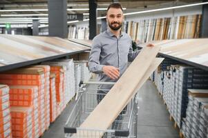 man choosing laminate samples in hardware store photo