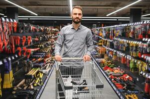 Portrait of happy mature man standing in hardware store photo