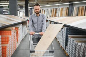 Man choosing flooring in hardware store photo