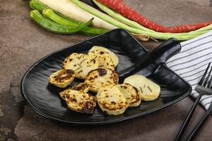 Baked potato slices with herbs photo