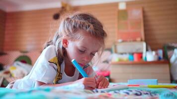 pequeno criança menina desenhar ou escrevendo dentro diário de lápis. video