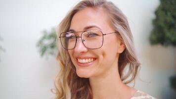 Confident woman wearing stylish eyeglasses and smiling at camera video