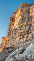 Sunlit Sandstone Cliff Formation photo