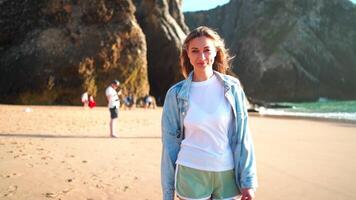 Smiling young woman running on sandy sea beach summer vacation video