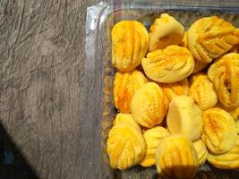 Close up of nastar cookies or pineapple tart lined up neatly on black cupcake paper. photo