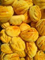 Close up of nastar cookies or pineapple tart lined up neatly on black cupcake paper. photo