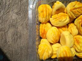 Close up of nastar cookies or pineapple tart lined up neatly on black cupcake paper. photo