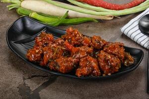 Manchurian chicken with sauce and spices photo