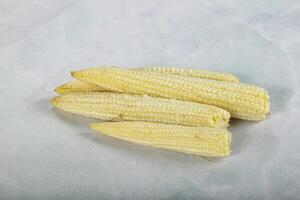 Raw sweet baby corn heap photo