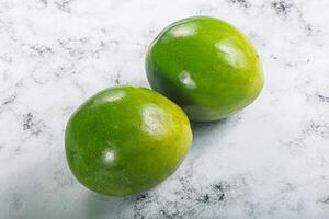 Two ripe green exotic avocado fruit photo