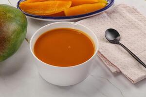 Sweet mango puree in the bowl photo