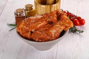 Raw turkey shoulder wing in Indian tandoori marinade photo