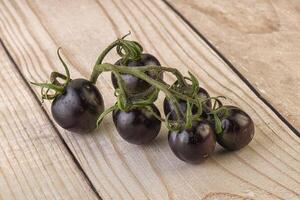 Ripe tasty black cherry tomato photo