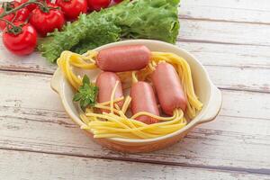 Mini sausages with pasta spaghetti photo