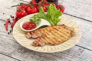 Grilled pork steak with ketchup photo