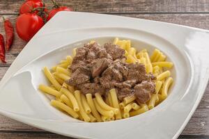 Creamy chicken liver with pasta photo