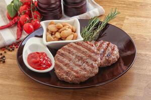 Grilled beef burger cutlet with sauce photo