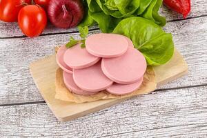 Slices boiled sausages for breakfast photo