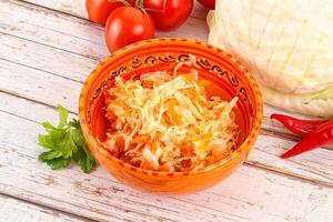 Fermented cabbage sauerkraut in the bowl photo