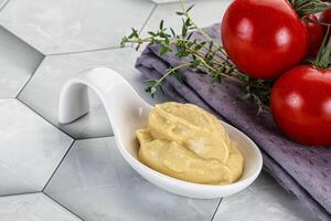 Dijon mustard sauce in the bowl photo