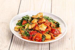 Chicken with tomato and spinach photo