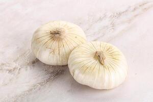 Raw white onion heap isolated photo